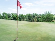 Golf green with flag on the Stegersbach golf swing course near Allegria Resort in Burgenland.