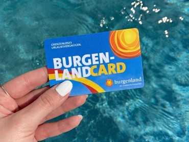 A hand is holding a card bearing the words 