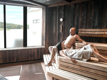 Two guests relaxing in the sauna at Allegria Resort Stegersbach within the stylish spa area.