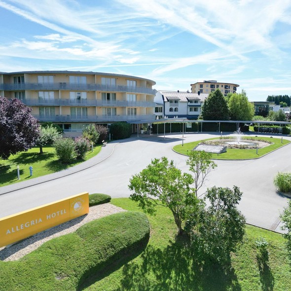 Exterior view of the Allegria Hotel with garden and entrance area.